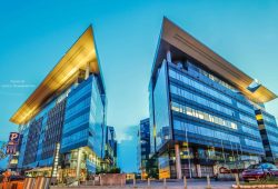 Futuristic glass office buildings at sunset in an urban area, conveying modern business architecture.