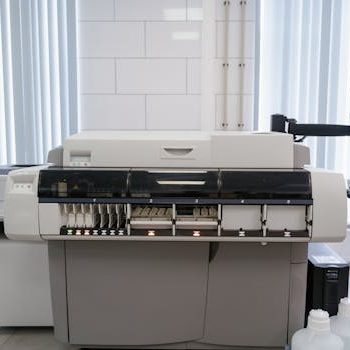 A high-tech office setup featuring a printer and computer workstation ready for productivity.